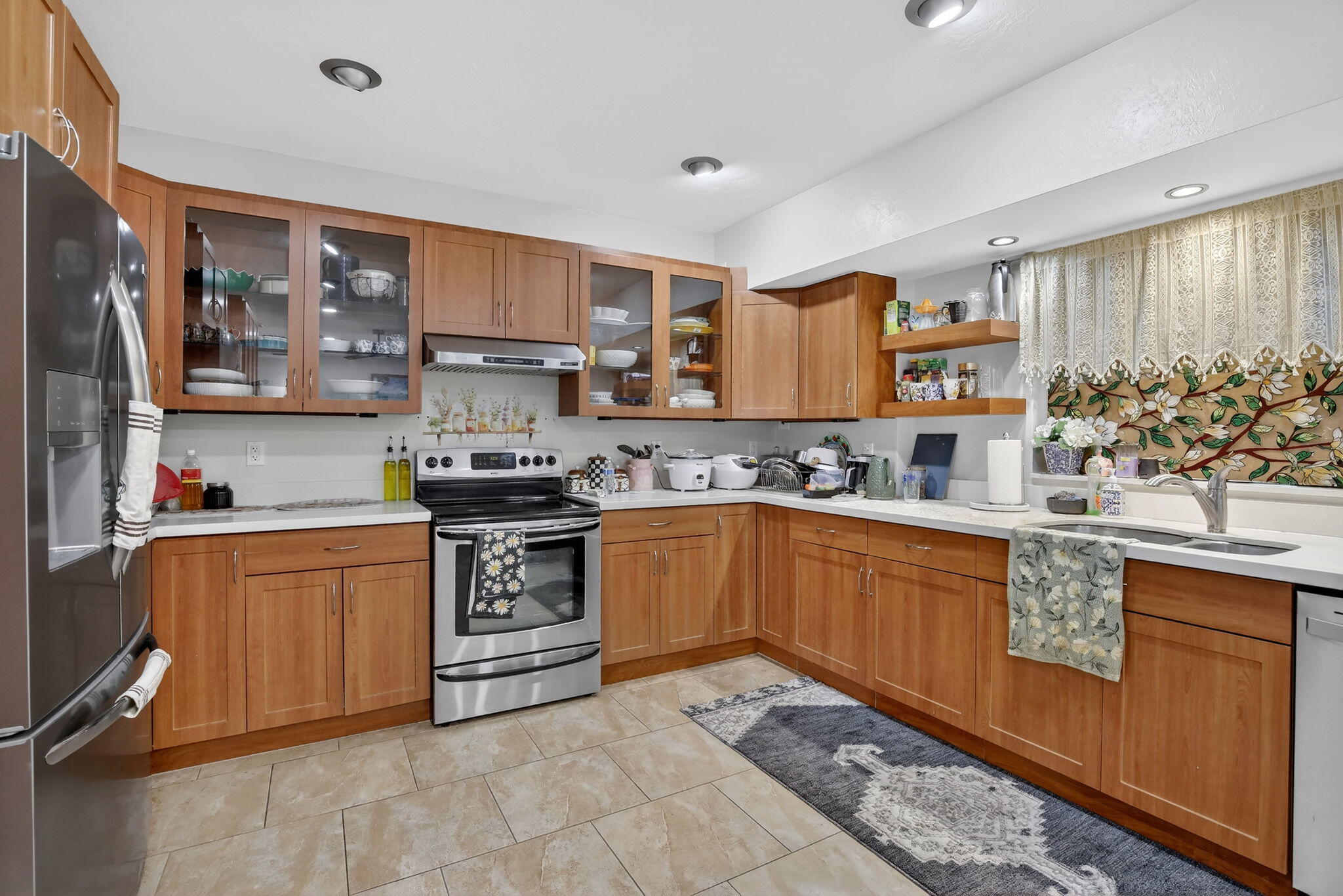 5507 McKinley Street Hollywood, FL 33021 - Photo 13 of 60 a kitchen with stainless steel appliances granite countertop a stove sink and cabinets