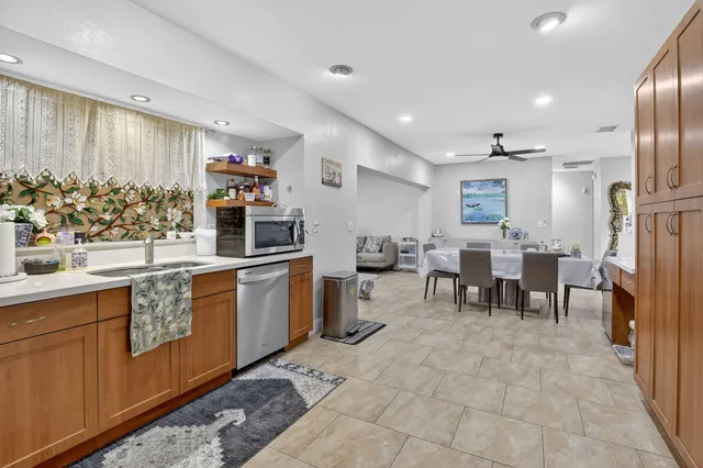 a kitchen with stainless steel appliances granite countertop a refrigerator and a stove
