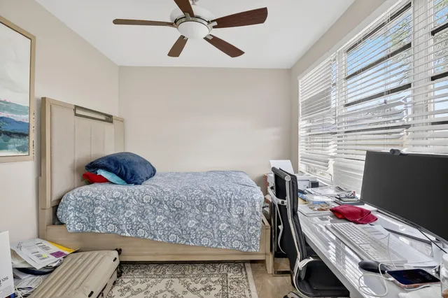 a bedroom with a bed and a chair