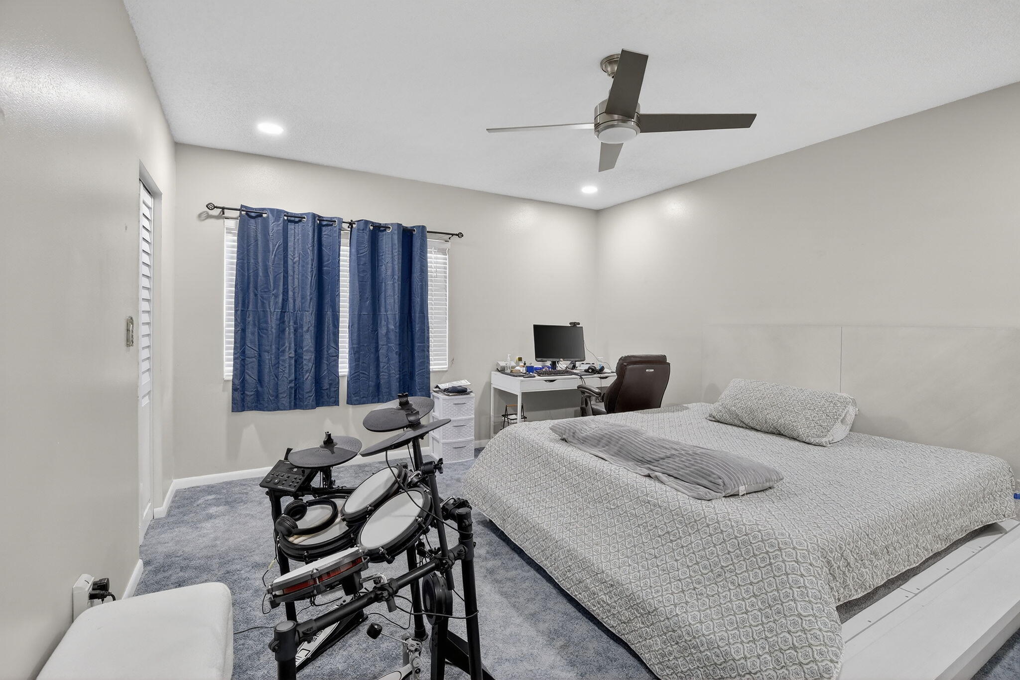 5507 McKinley Street Hollywood, FL 33021 - Photo 27 of 60 a bedroom with a bed and a chandelier