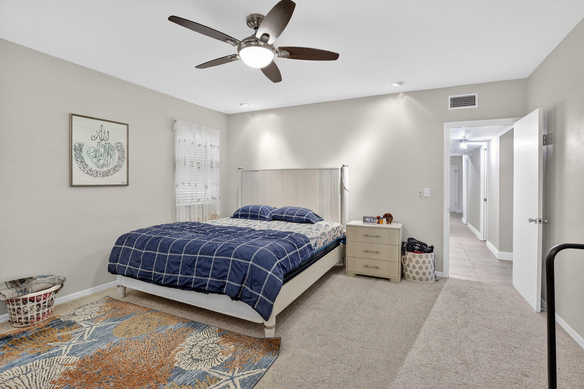 5507 McKinley Street Hollywood, FL 33021 - Photo 37 of 60 a spacious bedroom with a large bed and a chandelier