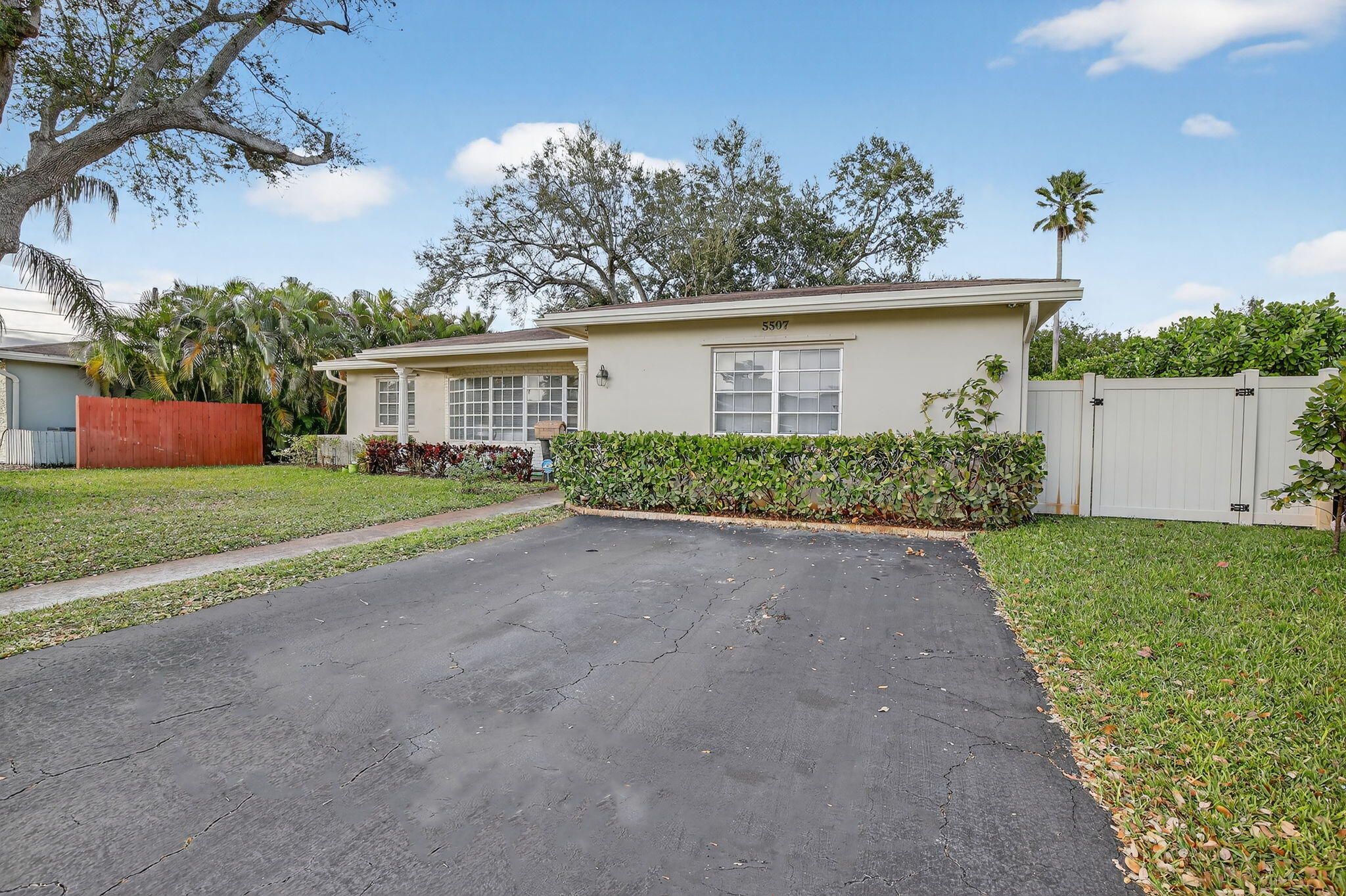 5507 McKinley Street Hollywood, FL 33021 - Photo 4 of 60 front view of house with a yard and potted plants