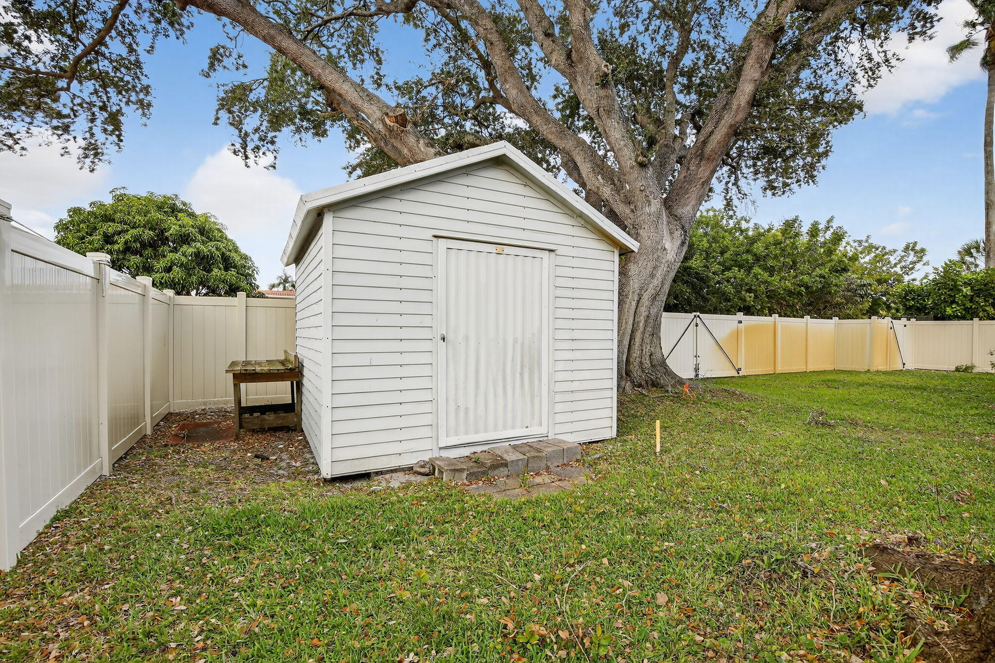 5507 McKinley Street Hollywood, FL 33021 - Photo 45 of 60 a view of backyard with small cabin and wooden fence