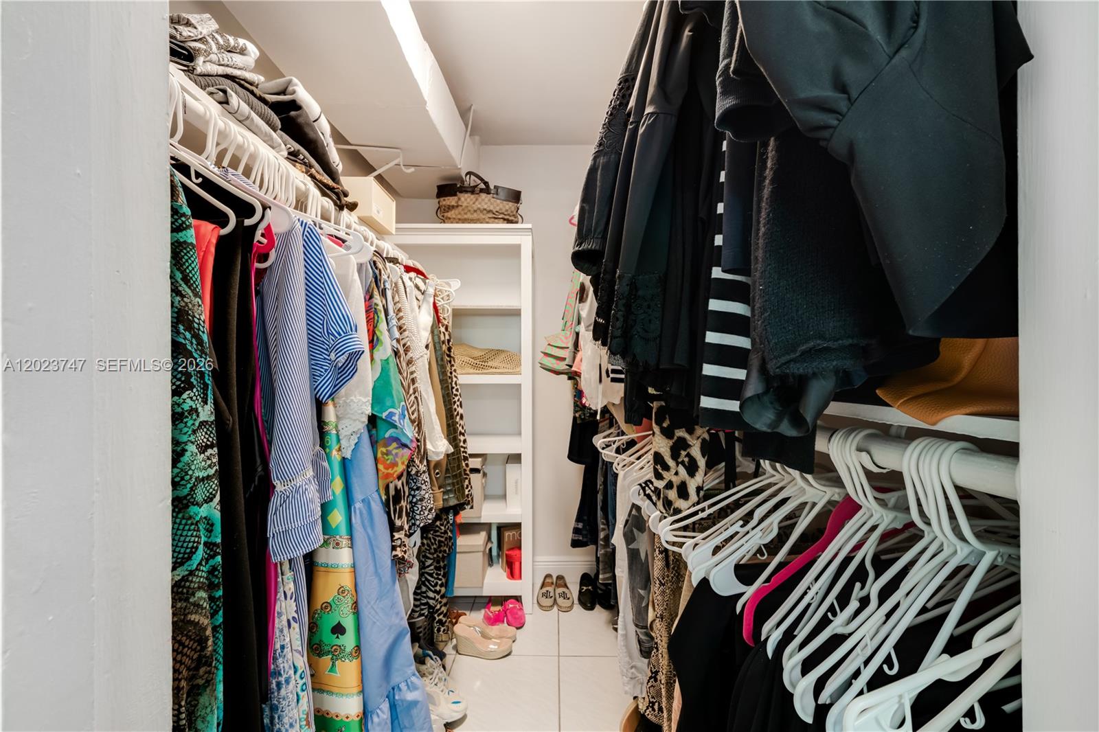11515 Southwest 81st Road, Unit 11515 Pinecrest, FL 33156 - Photo 29 of 33 a view of walk in closet with clothes and shoes
