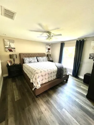 a bedroom with a bed and a night stand