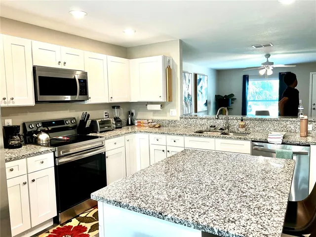 a kitchen with a sink stove and microwave