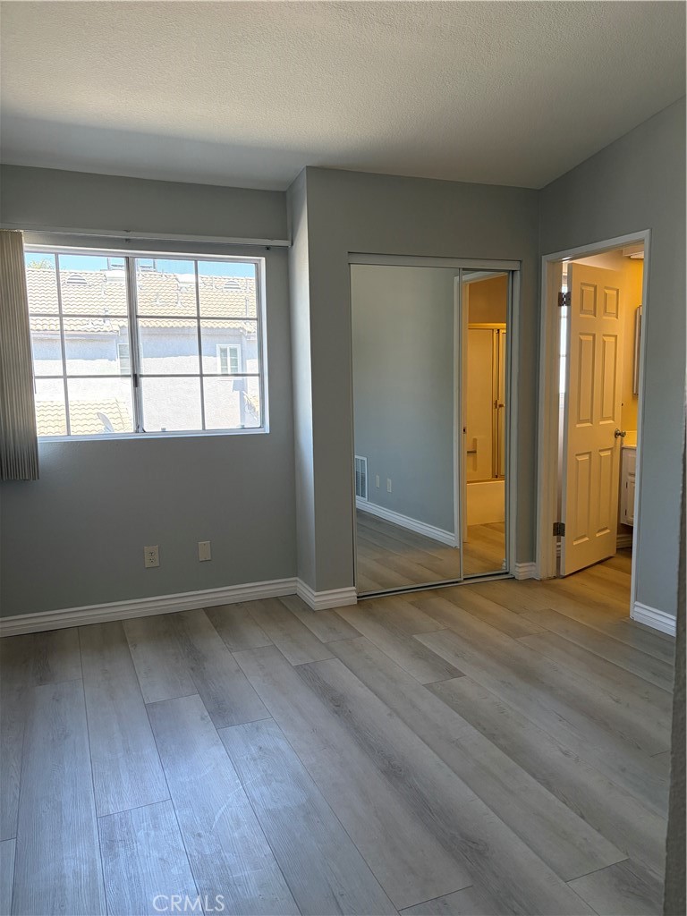 8248 Inglenook Place Rancho Cucamonga, CA 91730 - Photo 4 of 12 an empty room with wooden floor and windows