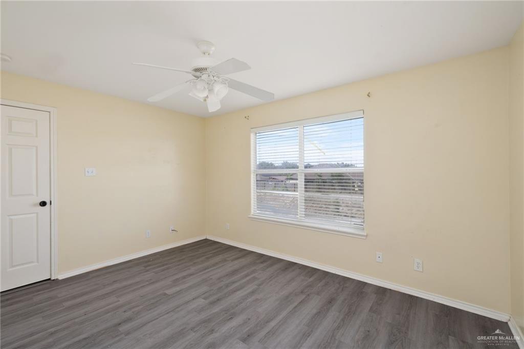 2601 Nassau Street Edinburg, TX 78541 - Photo 8 of 15 wooden floor in an empty room with a window