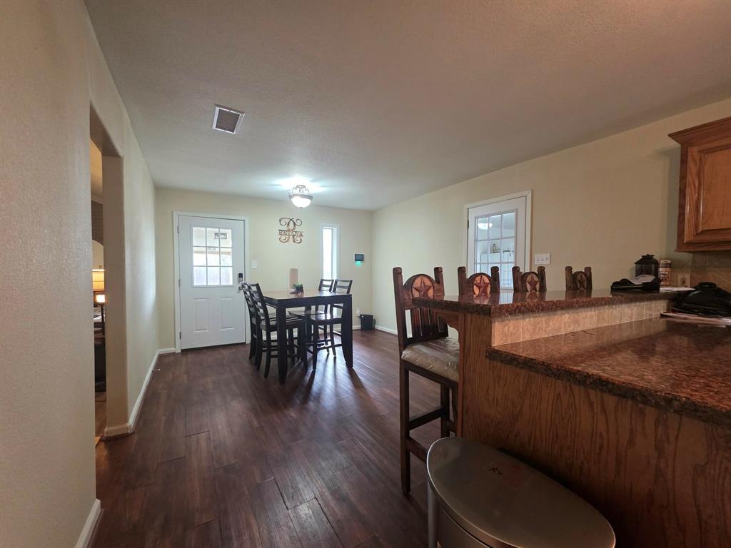 739 Bluebonnet Street Mexia, TX 76667 - Photo 12 of 28 a view of a dining room with furniture and wooden floor