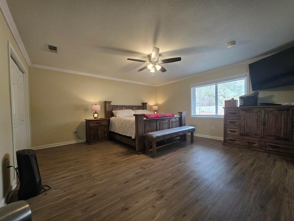 739 Bluebonnet Street Mexia, TX 76667 - Photo 13 of 28 a living room with furniture and a flat screen tv