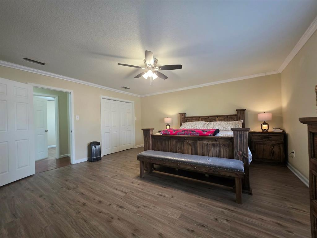 739 Bluebonnet Street Mexia, TX 76667 - Photo 14 of 28 a bedroom with furniture and a chandelier