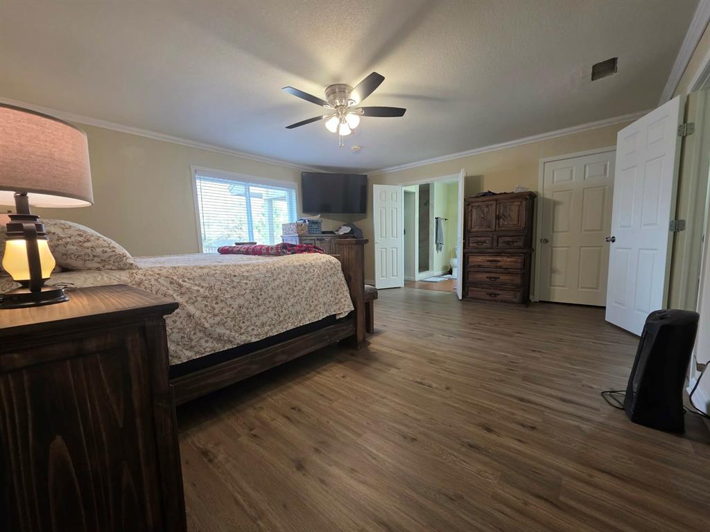 739 Bluebonnet Street Mexia, TX 76667 - Photo 15 of 28 a bedroom with a bed and wooden floor