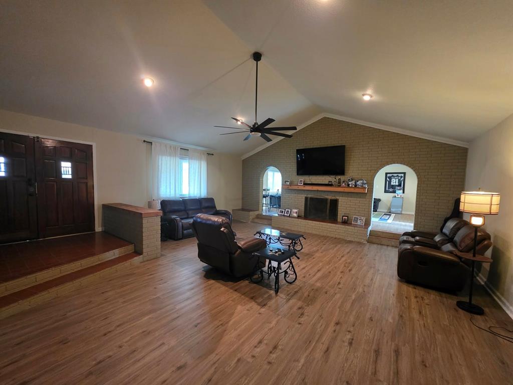 739 Bluebonnet Street Mexia, TX 76667 - Photo 3 of 28 a living room with furniture a fireplace and a flat screen tv