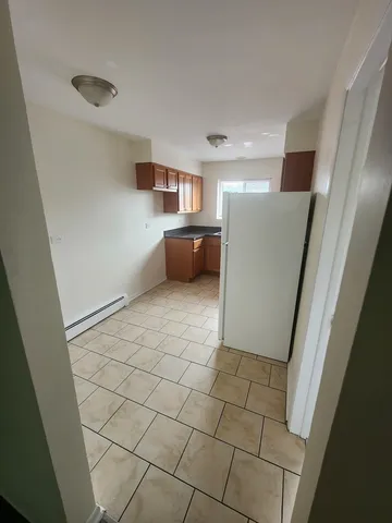 a view of a hallway to rooms and stairs