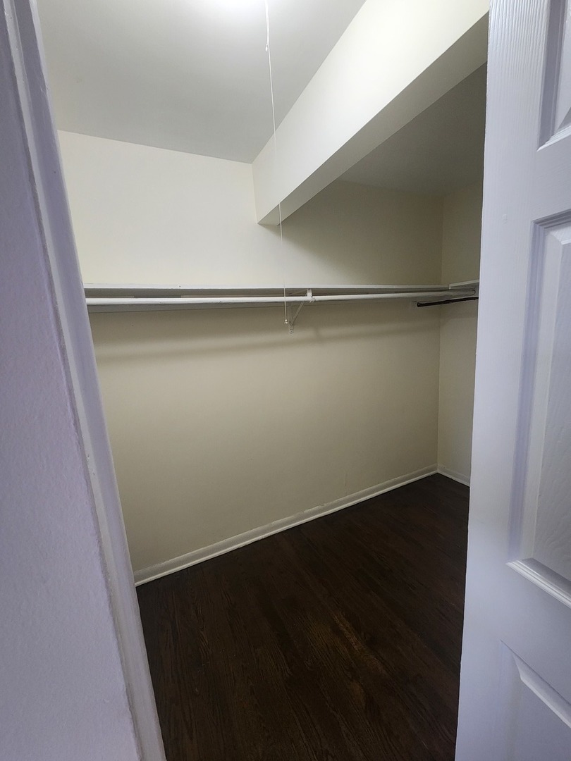 7455 North Ridge Boulevard, Unit C2 Chicago, IL 60645 - Photo 7 of 9 an empty room with wooden floor