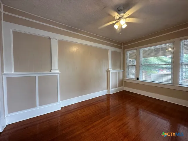 wooden floor in an empty room with a window