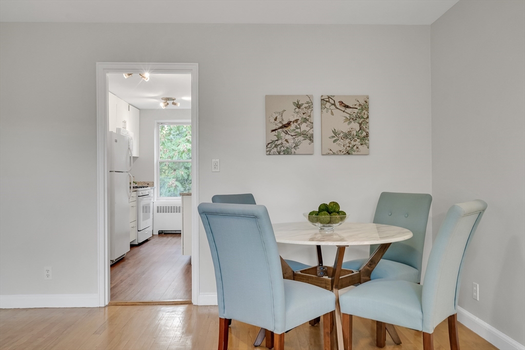 136 Beaconsfield Road, Unit 6 Brookline, MA 02445 - Photo 5 of 17 a view of a dining room with furniture and wooden floor