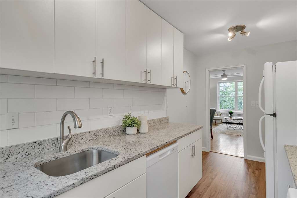 136 Beaconsfield Road, Unit 6 Brookline, MA 02445 - Photo 8 of 17 a kitchen with a sink and cabinets
