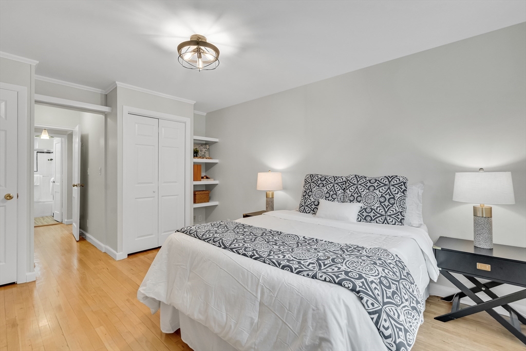 136 Beaconsfield Road, Unit 6 Brookline, MA 02445 - Photo 10 of 17 a bedroom with a bed and wooden floor