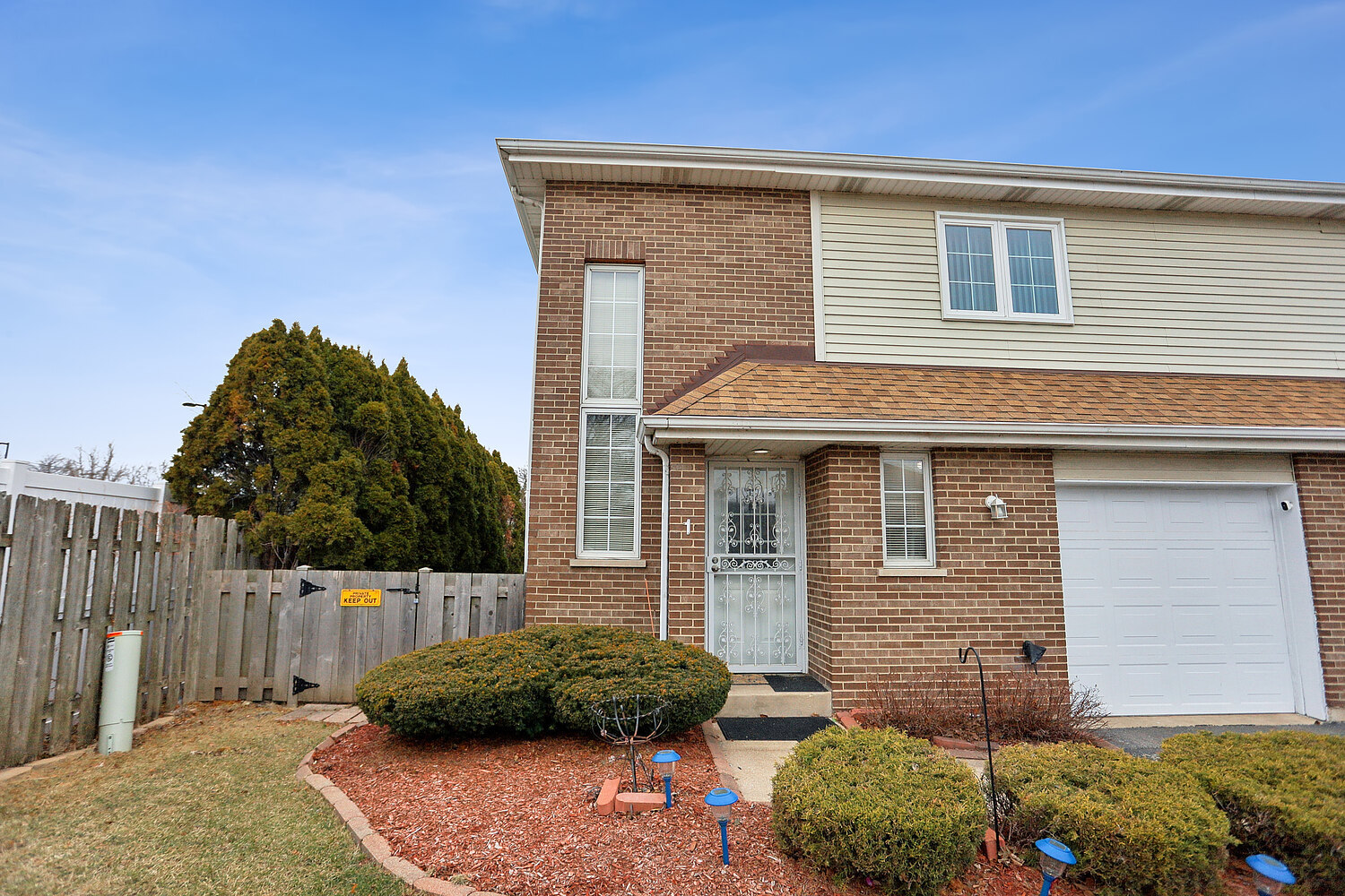 11030 South Roberts Road, Unit 1 Palos Hills, IL 60465 - Photo 1 of 16 a front view of a house with a yard
