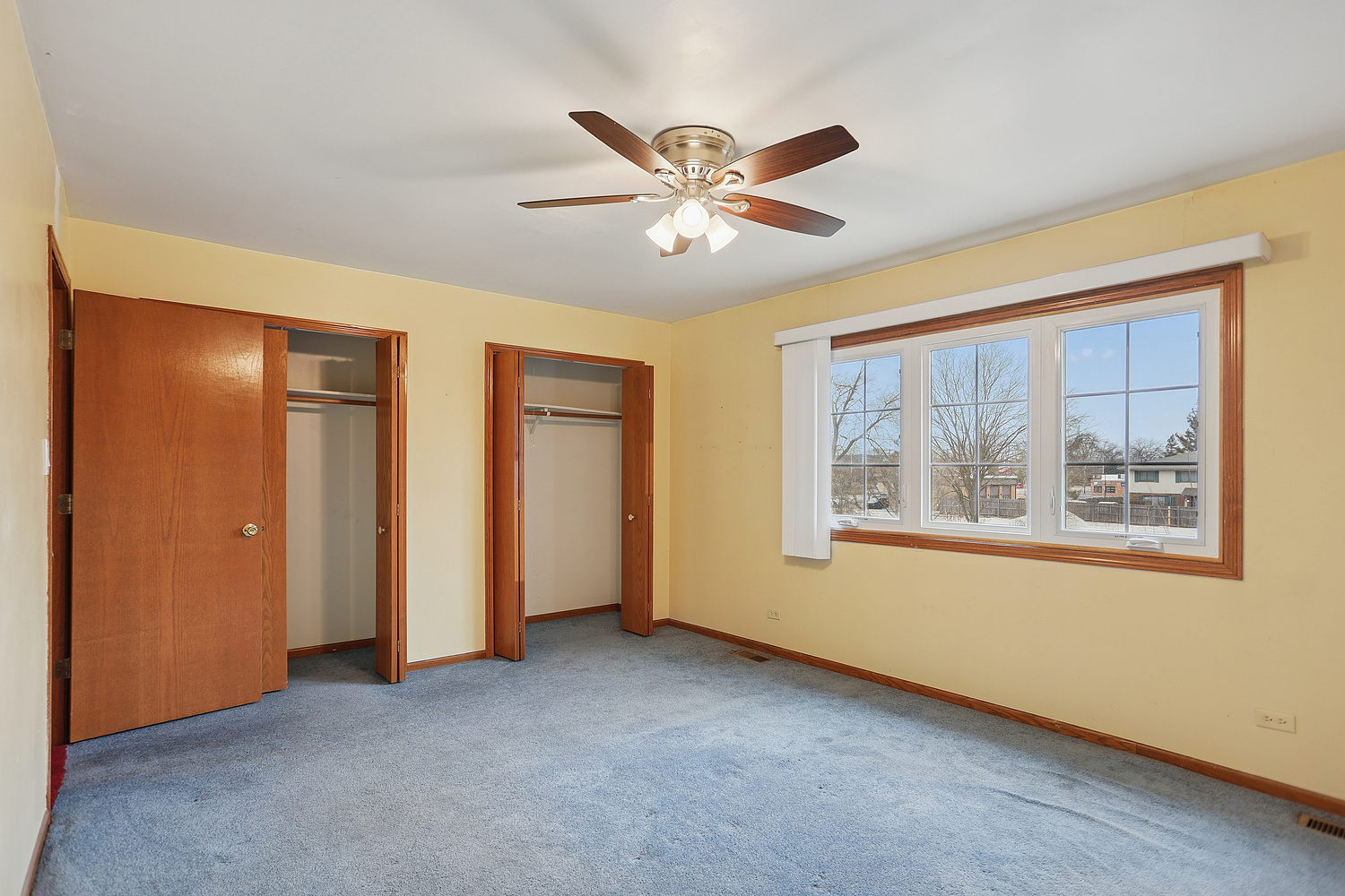 11030 South Roberts Road, Unit 1 Palos Hills, IL 60465 - Photo 11 of 16 a view of an empty room with window and a ceiling fan