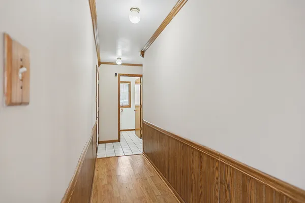 a view of a hallway with wooden floor