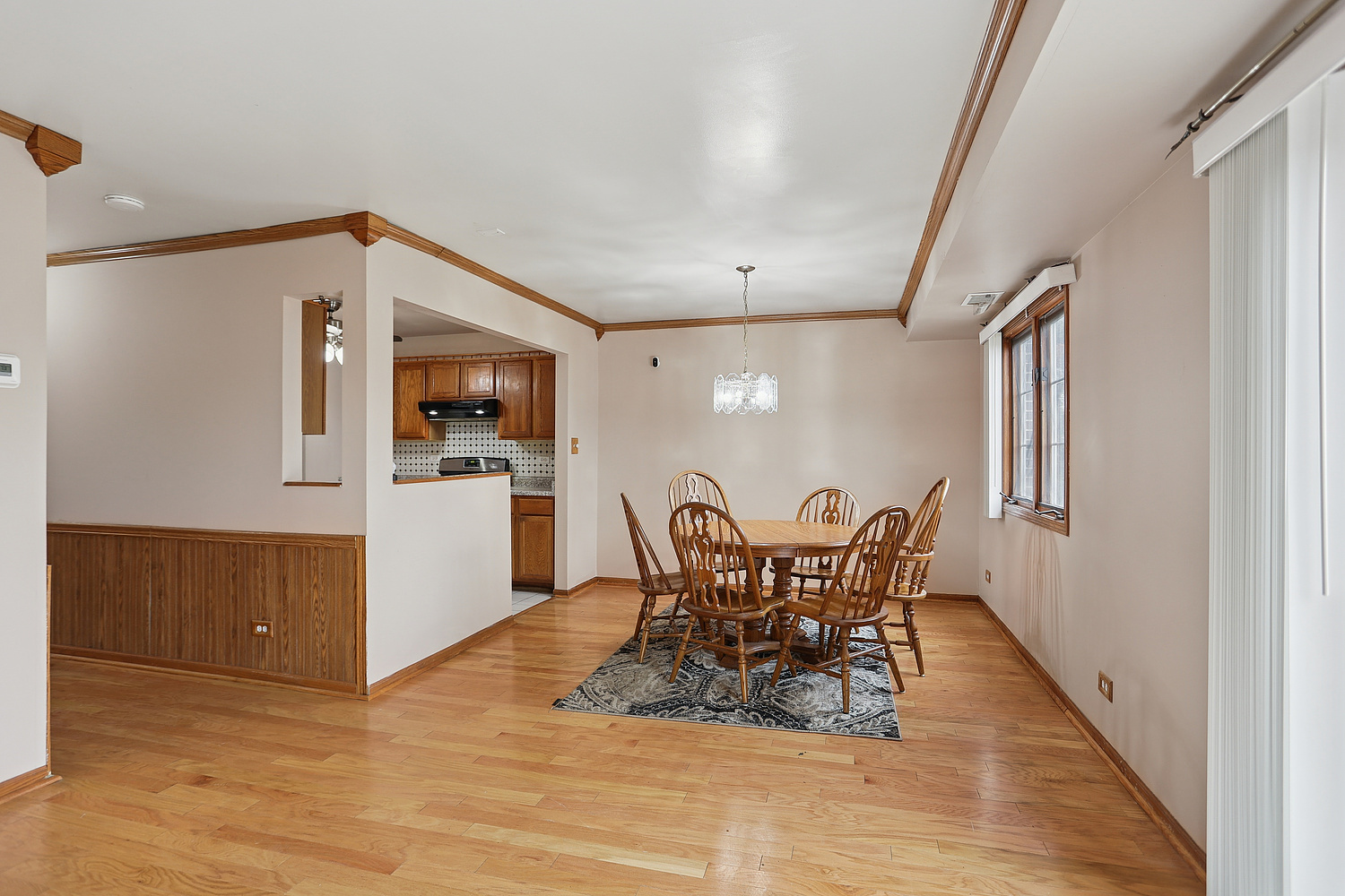 11030 South Roberts Road, Unit 1 Palos Hills, IL 60465 - Photo 5 of 16 a view of a dining room with furniture and wooden floor