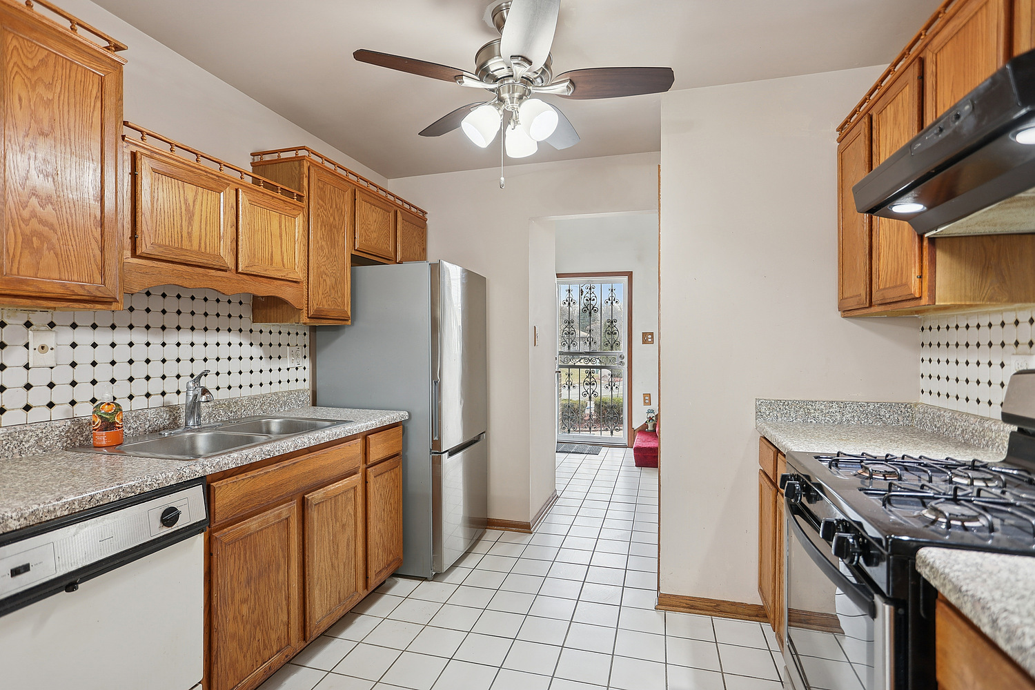 11030 South Roberts Road, Unit 1 Palos Hills, IL 60465 - Photo 7 of 16 a kitchen with stainless steel appliances granite countertop a refrigerator a sink dishwasher stove and white countertops with wooden floor