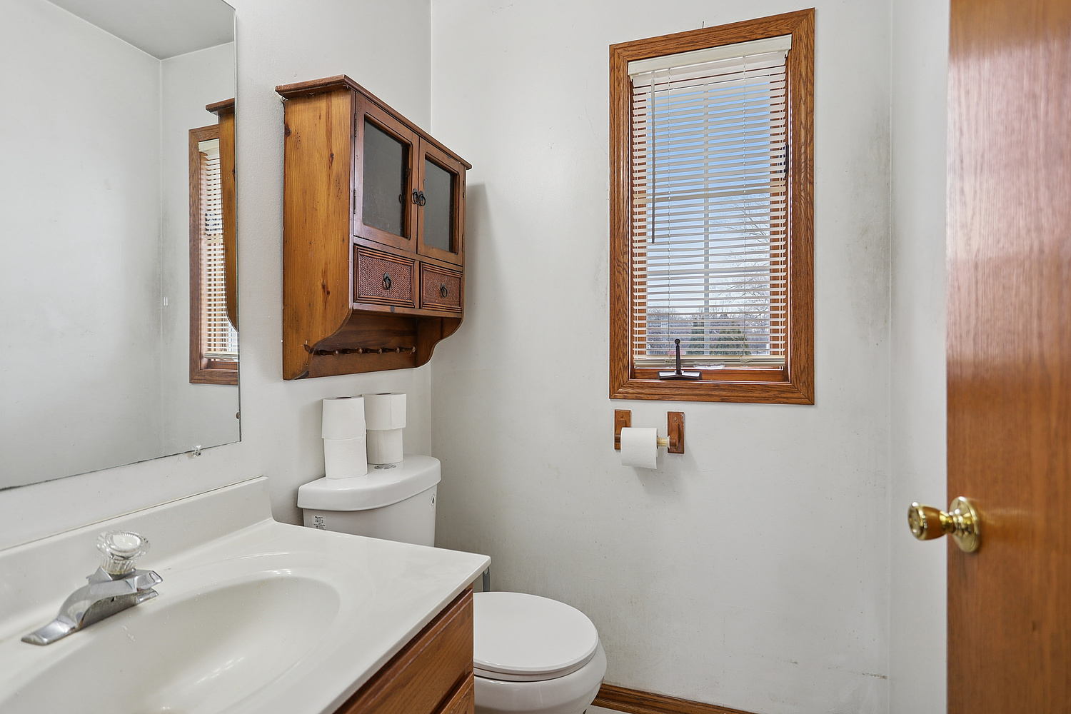 11030 South Roberts Road, Unit 1 Palos Hills, IL 60465 - Photo 9 of 16 a bathroom with a sink a toilet and mirror