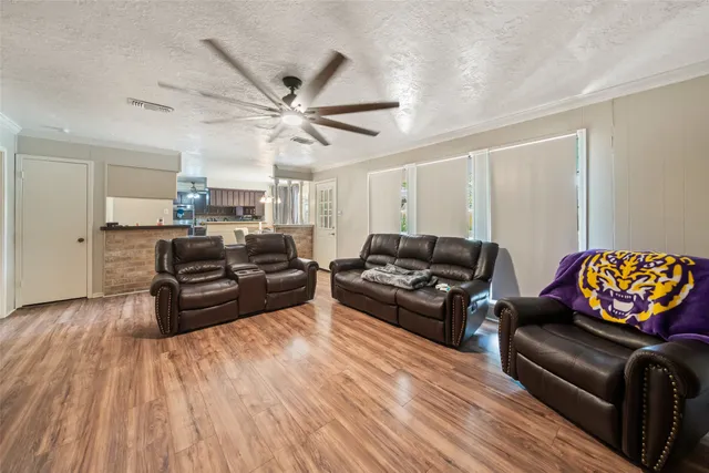 a living room with furniture and wooden floor