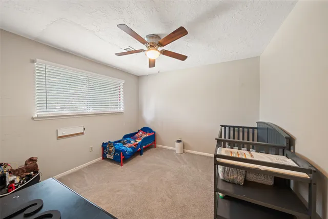 a view of a room with toys and a ceiling fan