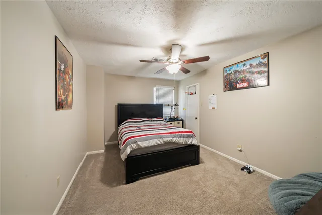a bedroom with bed and a chandelier