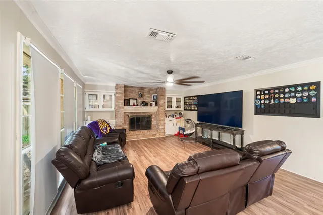 a living room with furniture a flat screen tv and a fireplace