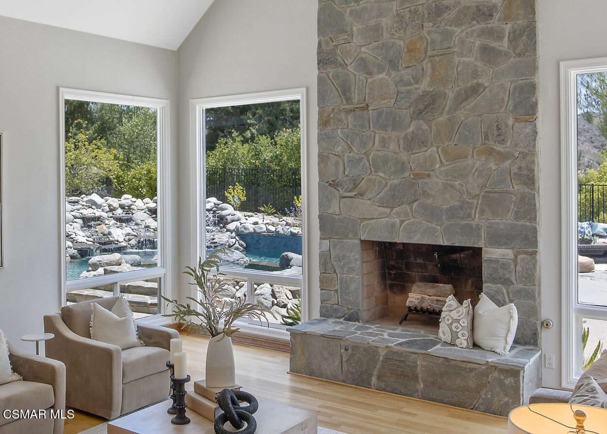 3840 Castle View Road Agoura Hills, CA 91301 - Photo 11 of 94 a living room with furniture large window and a fireplace