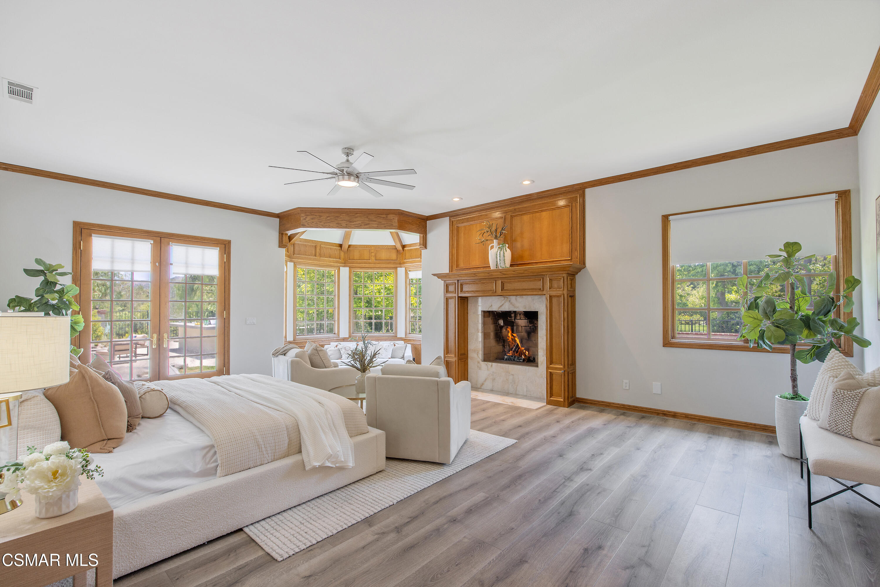 3840 Castle View Road Agoura Hills, CA 91301 - Photo 31 of 94 a spacious bedroom with a balcony a bed and a fireplace