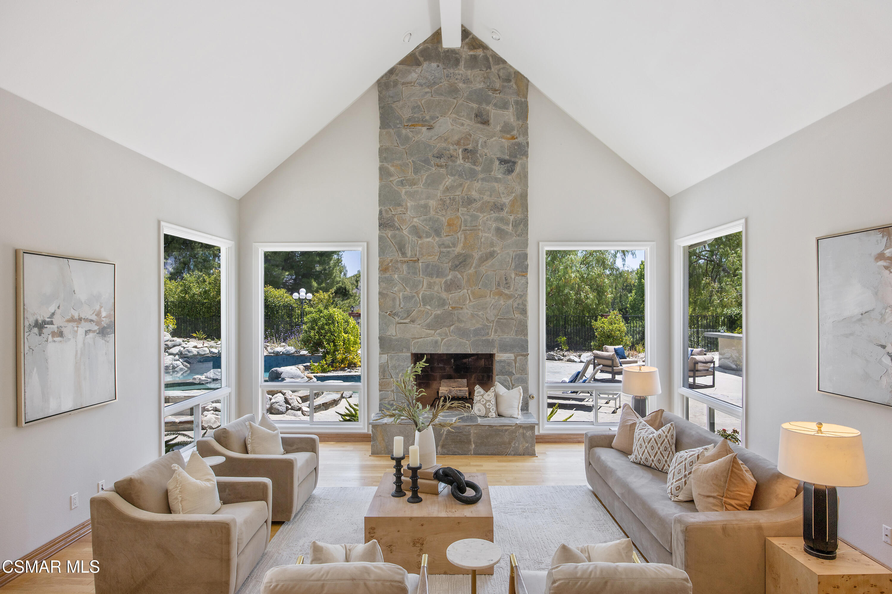3840 Castle View Road Agoura Hills, CA 91301 - Photo 9 of 94 a living room with furniture fireplace and a large window