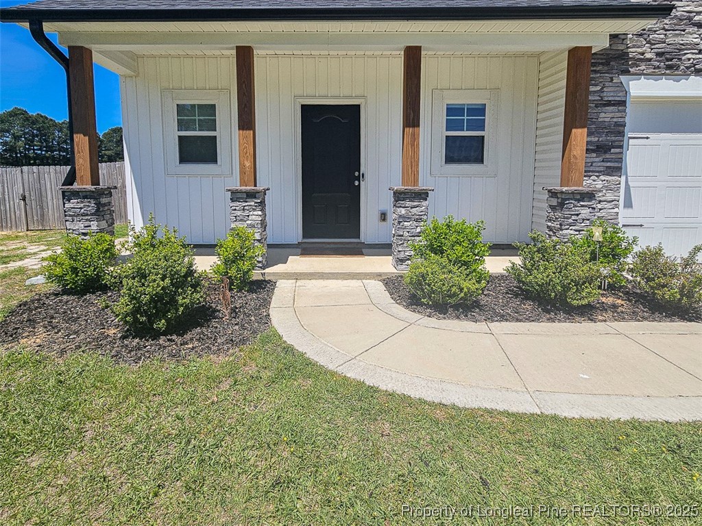 7837 Maxwell Road Stedman, NC 28391 - Photo 3 of 11 front view of a house with potted plants