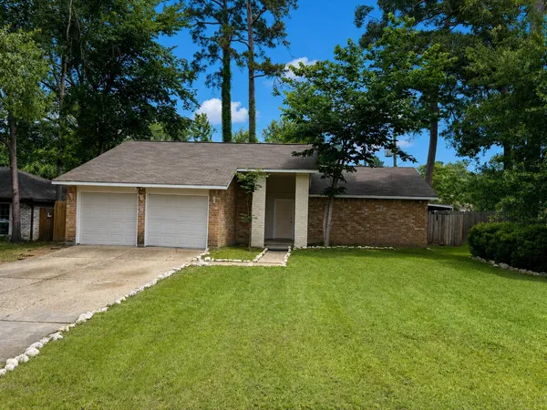 a front view of a house with a garden and yard