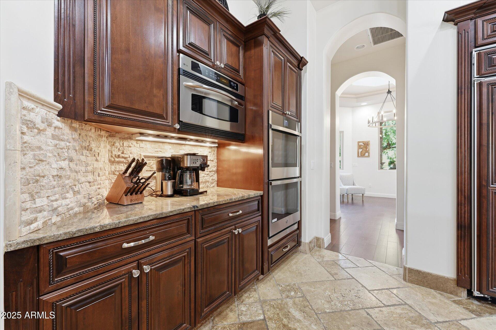 3121 East Bonanza Court Gilbert, AZ 85297 - Photo 25 of 83 a kitchen with stainless steel appliances granite countertop a refrigerator and a sink