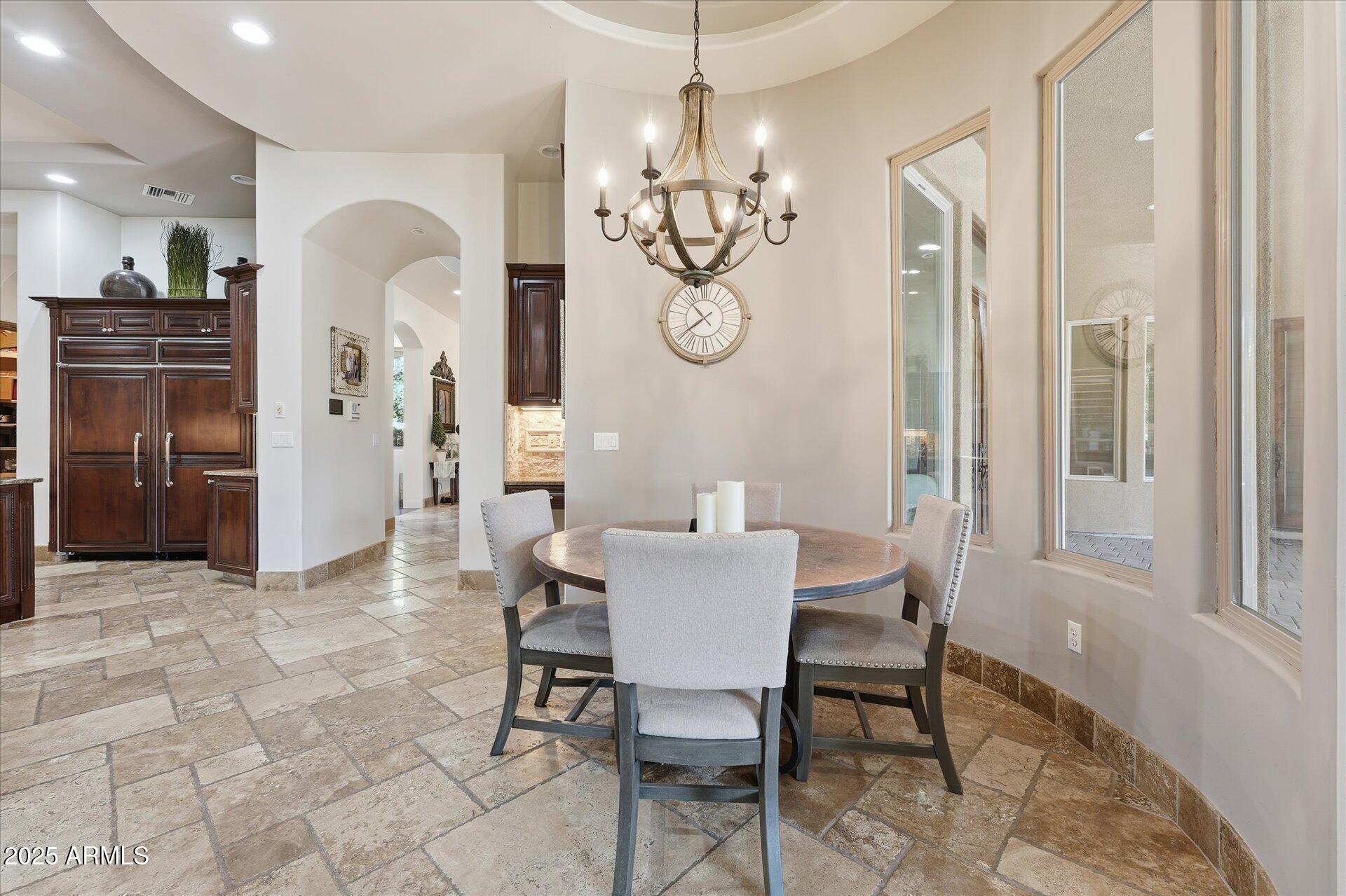 3121 East Bonanza Court Gilbert, AZ 85297 - Photo 26 of 83 a view of a dining room with furniture and chandelier