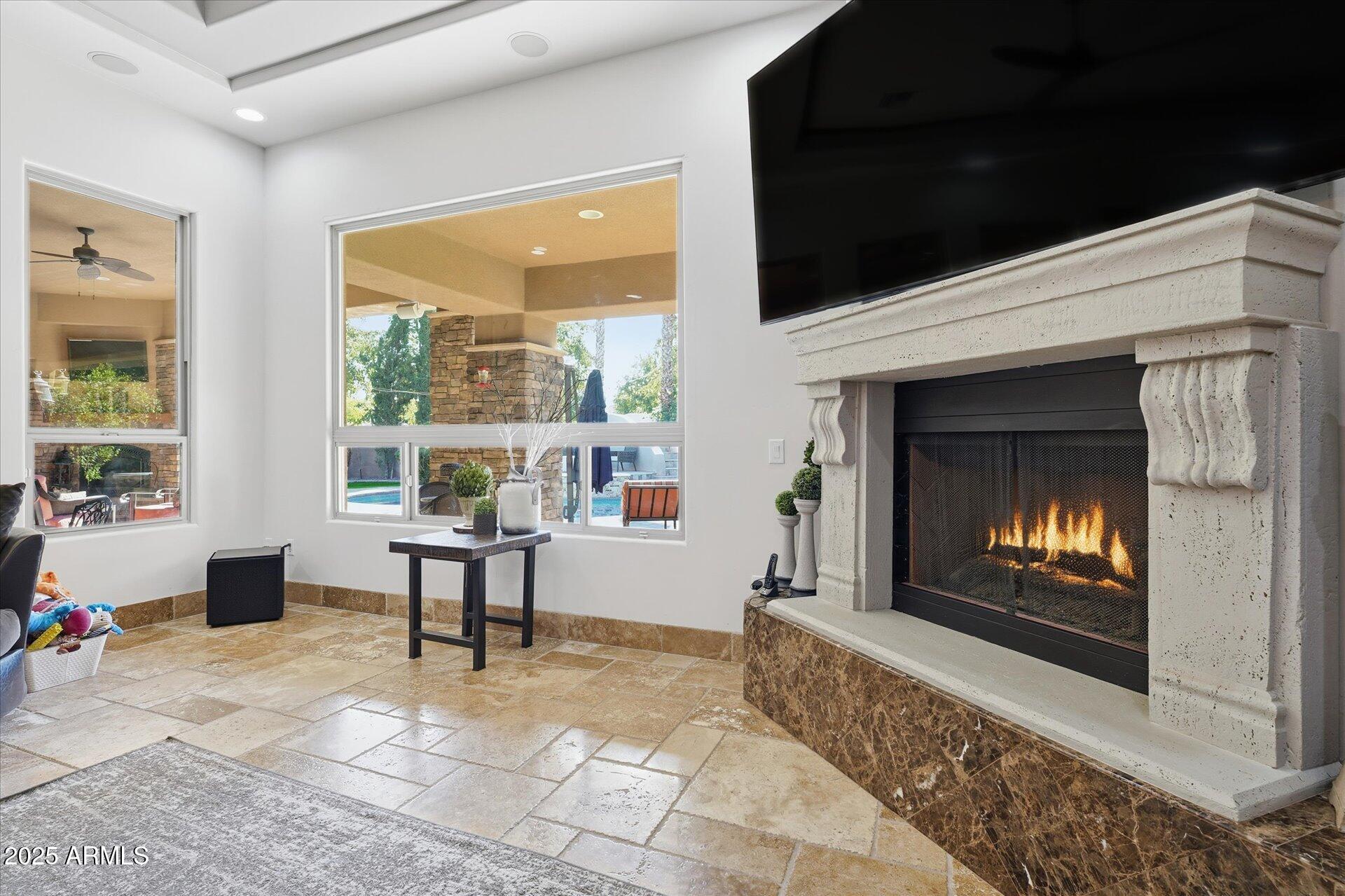 3121 East Bonanza Court Gilbert, AZ 85297 - Photo 30 of 83 a living room with furniture and a fireplace