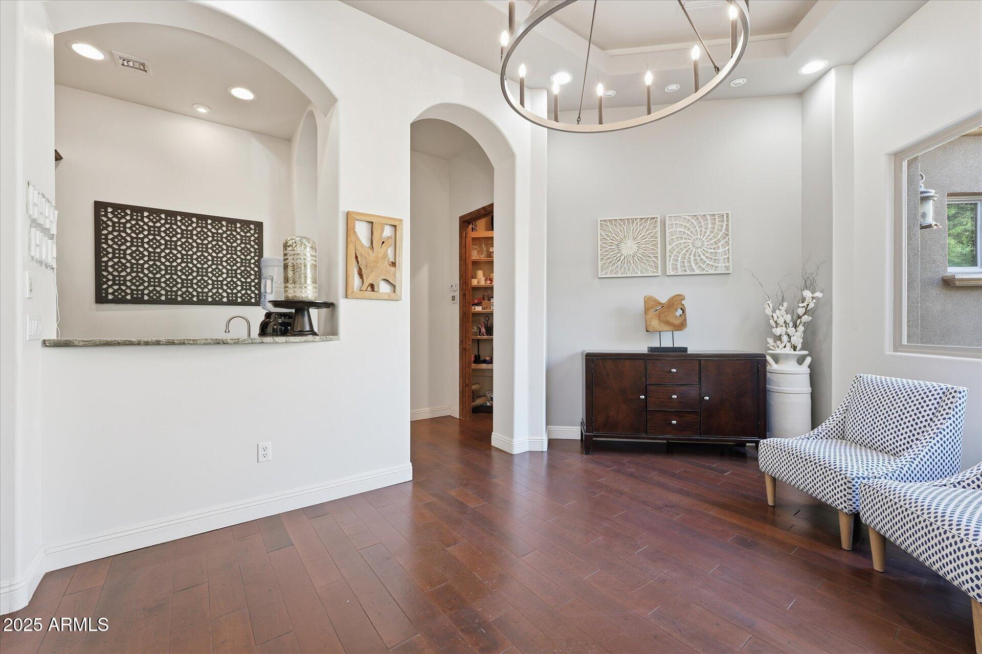 3121 East Bonanza Court Gilbert, AZ 85297 - Photo 31 of 83 a living room with furniture and a chandelier
