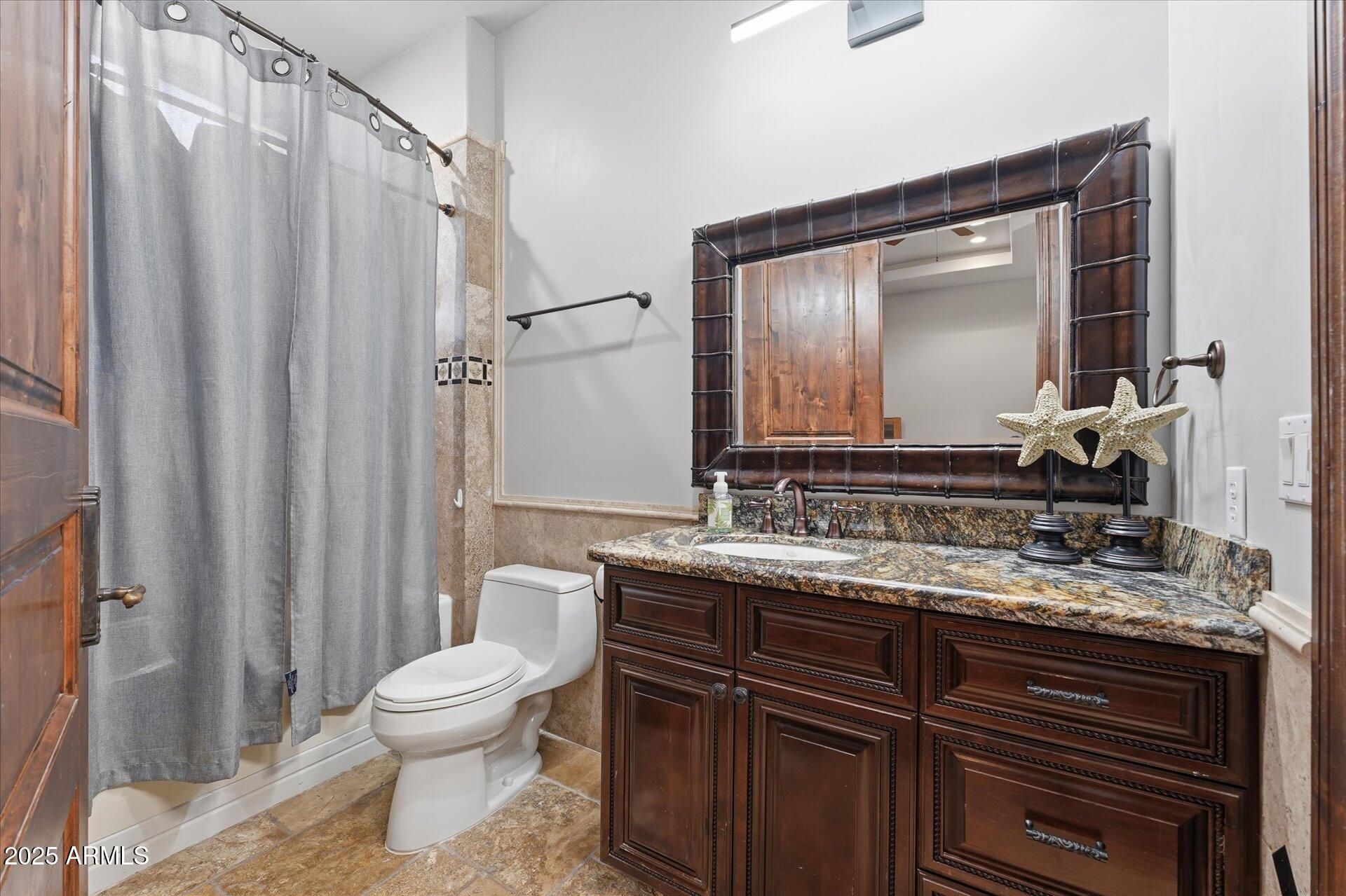 3121 East Bonanza Court Gilbert, AZ 85297 - Photo 54 of 83 a bathroom with a granite countertop sink toilet and mirror