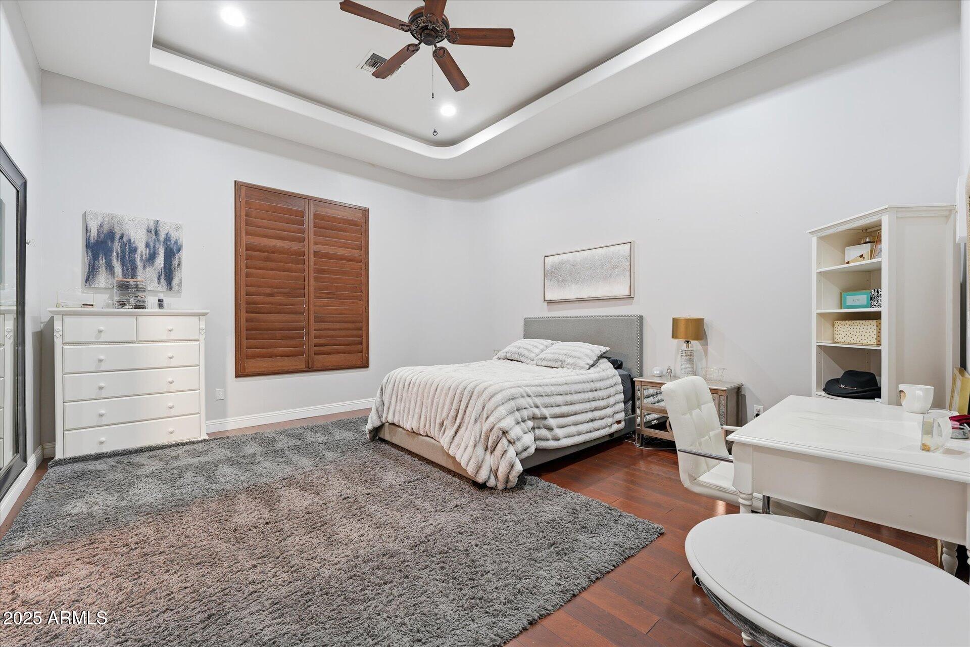 3121 East Bonanza Court Gilbert, AZ 85297 - Photo 56 of 83 a spacious bedroom with a bed a dresser and a chandelier