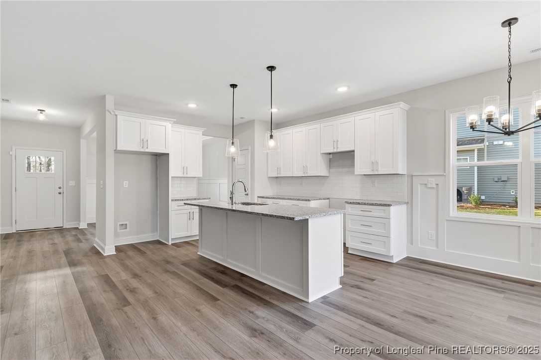 2154 Montrose (lot 6) Road Raeford, NC 28376 - Photo 15 of 44 a large kitchen with granite countertop a large counter top a sink stainless steel appliances and cabinets