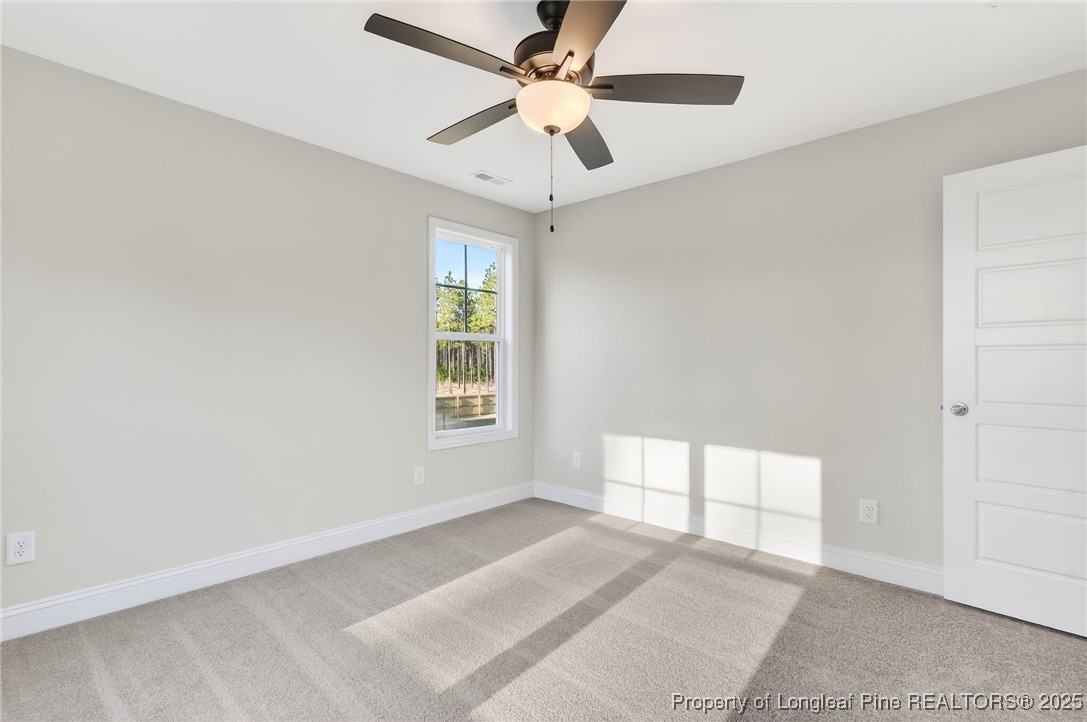 2154 Montrose (lot 6) Road Raeford, NC 28376 - Photo 26 of 44 an empty room with chandelier fan and windows