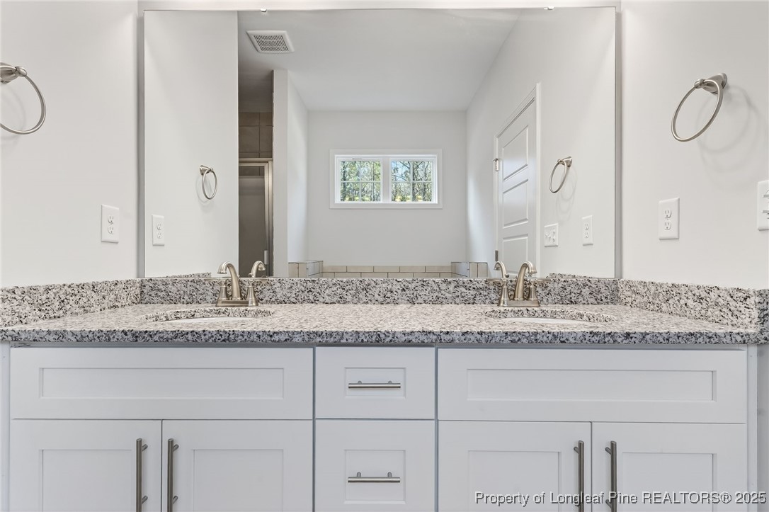 2154 Montrose (lot 6) Road Raeford, NC 28376 - Photo 35 of 44 a bathroom with a granite countertop sink and a mirror