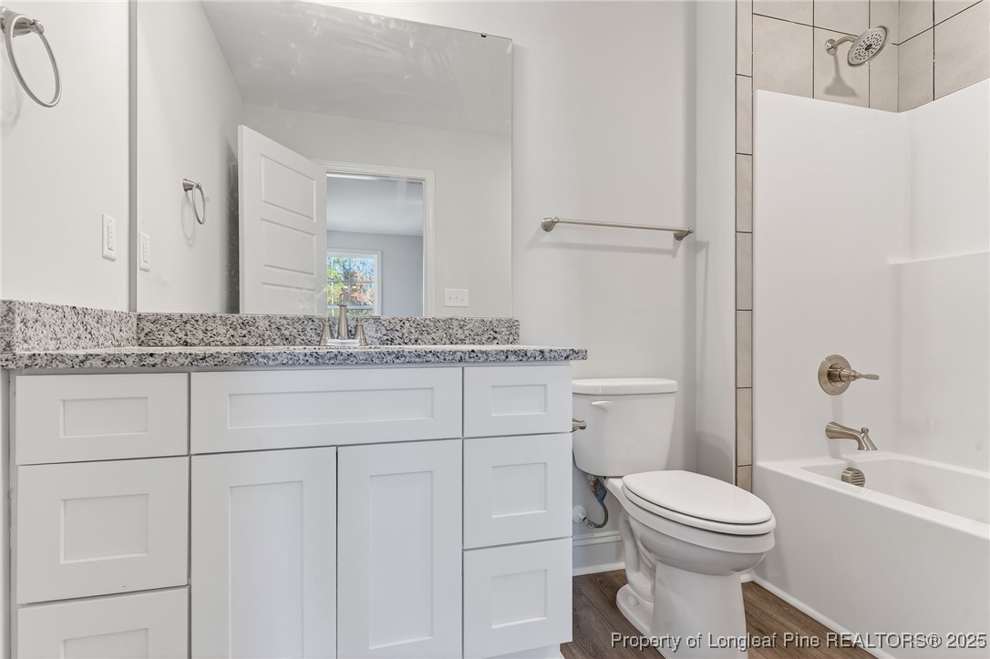 2154 Montrose (lot 6) Road Raeford, NC 28376 - Photo 36 of 44 a bathroom with a granite countertop sink toilet a mirror and shower