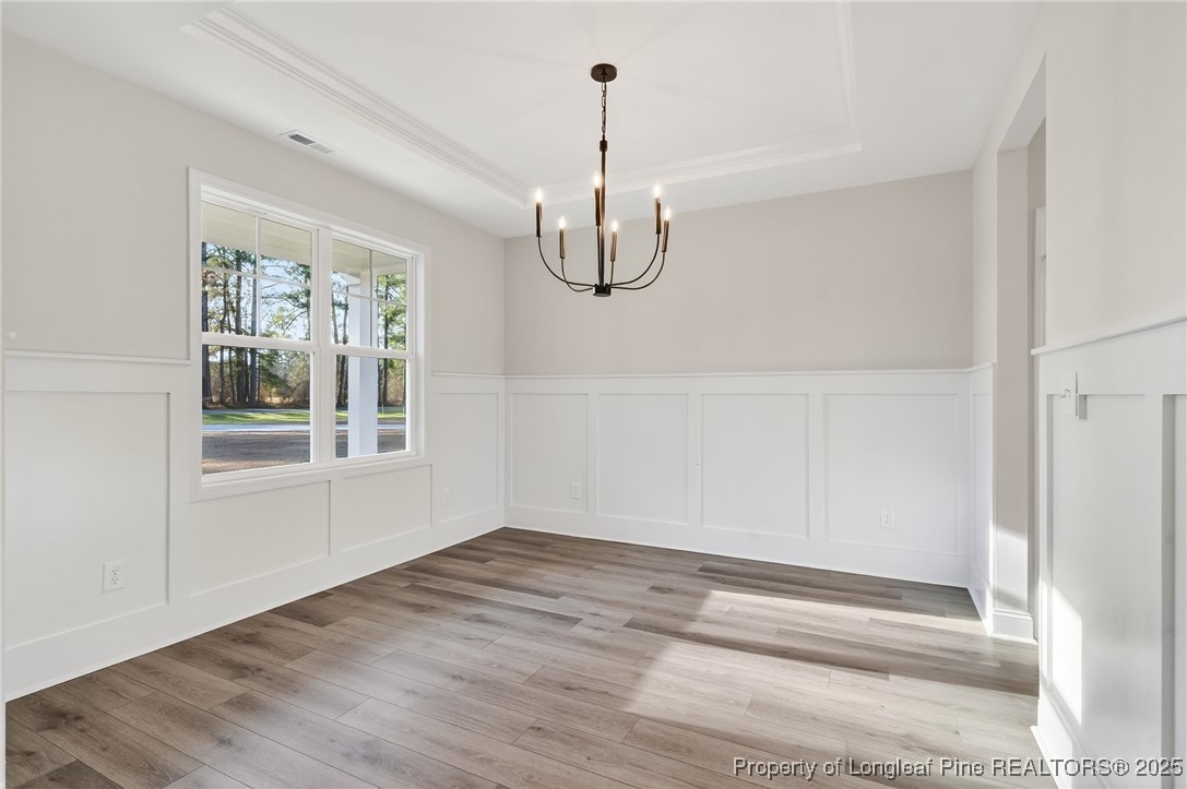 2154 Montrose (lot 6) Road Raeford, NC 28376 - Photo 5 of 44 a view of a room with wooden floor exposed radiator and windows