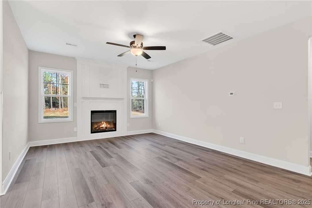 2154 Montrose (lot 6) Road Raeford, NC 28376 - Photo 8 of 44 a view of empty room with wooden floor and fireplace